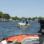 Coast Guard boat crew from Station Fire Island escorting a recreational boat back to the pier near Fire Island, New York