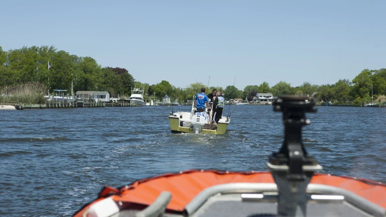 Coast Guard boat crew from Station Fire Island escorting a recreational boat back to the pier near Fire Island, New York