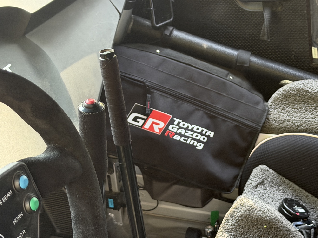 Stripped rally cockpit of the Toyota GR Corolla with full roll cage, carbon door cards and hydraulic handbrake