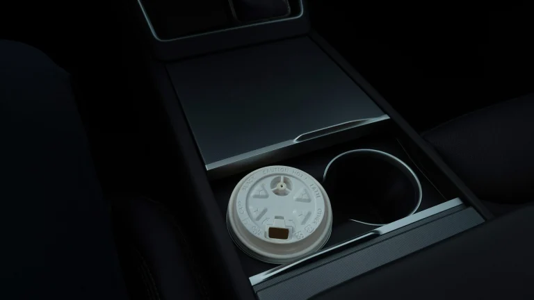 Disposable coffee cup sitting in a car cup holder