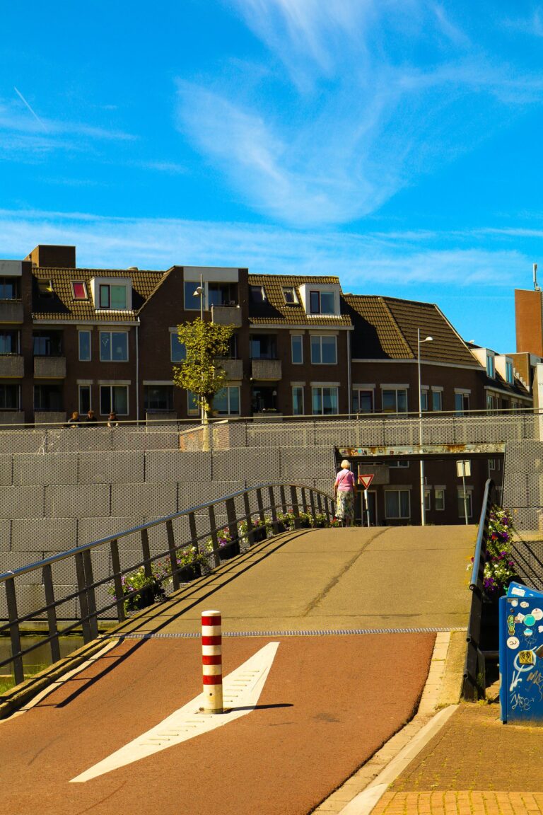 A cyclist riding a separated shared-use path across a modern bridge