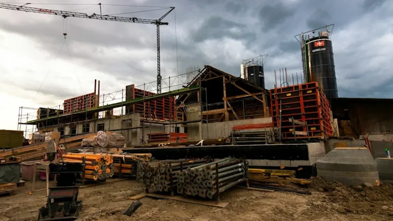 Construction site with a crane and formwork under a stormy sky