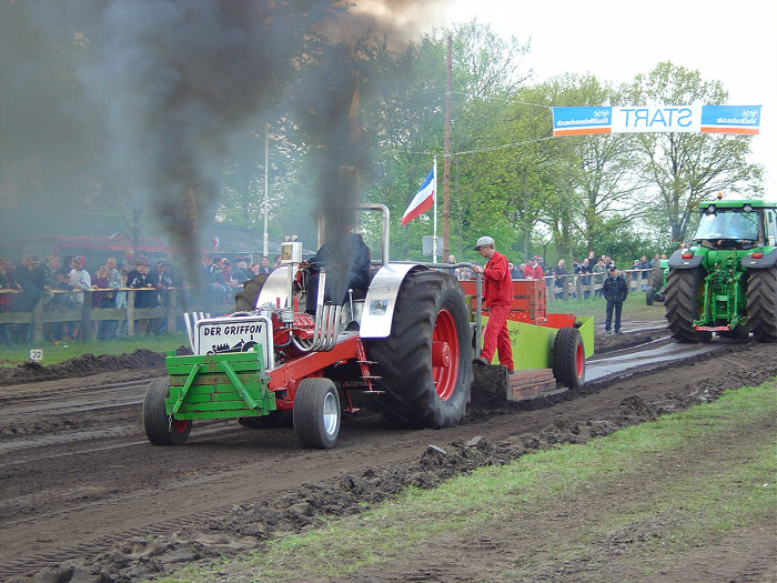 Diesel pulling tractor throwing black smoke at a tractor pull competition