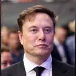Elon Musk in a dark suit and tie
