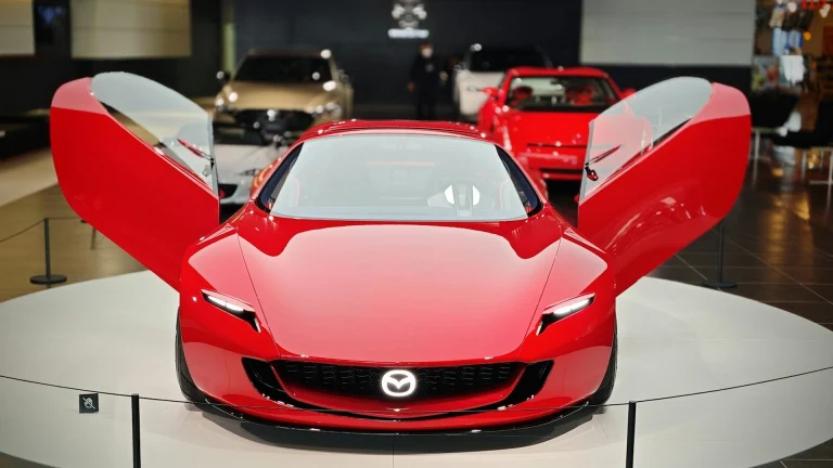 A red sports car on display in a showroom