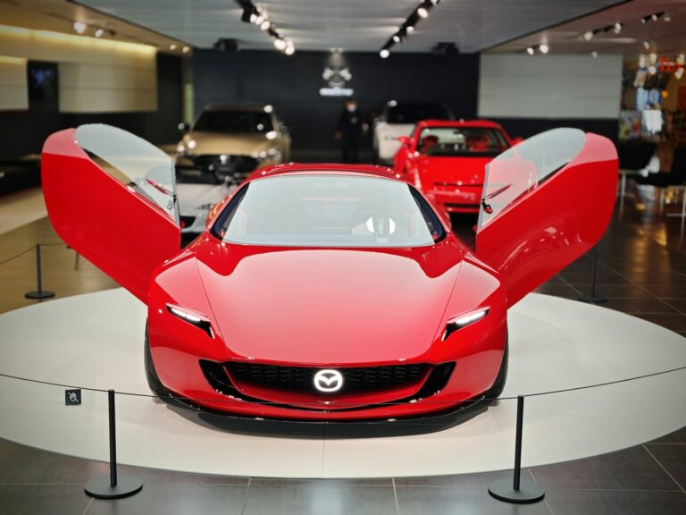 A red sports car on display in a showroom