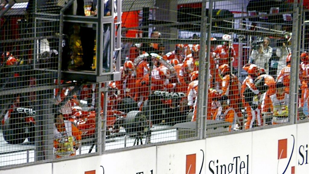 Ferrari crew in the pit lane at the 2008 Singapore Grand Prix after Felipe Massa’s fuel hose mishap