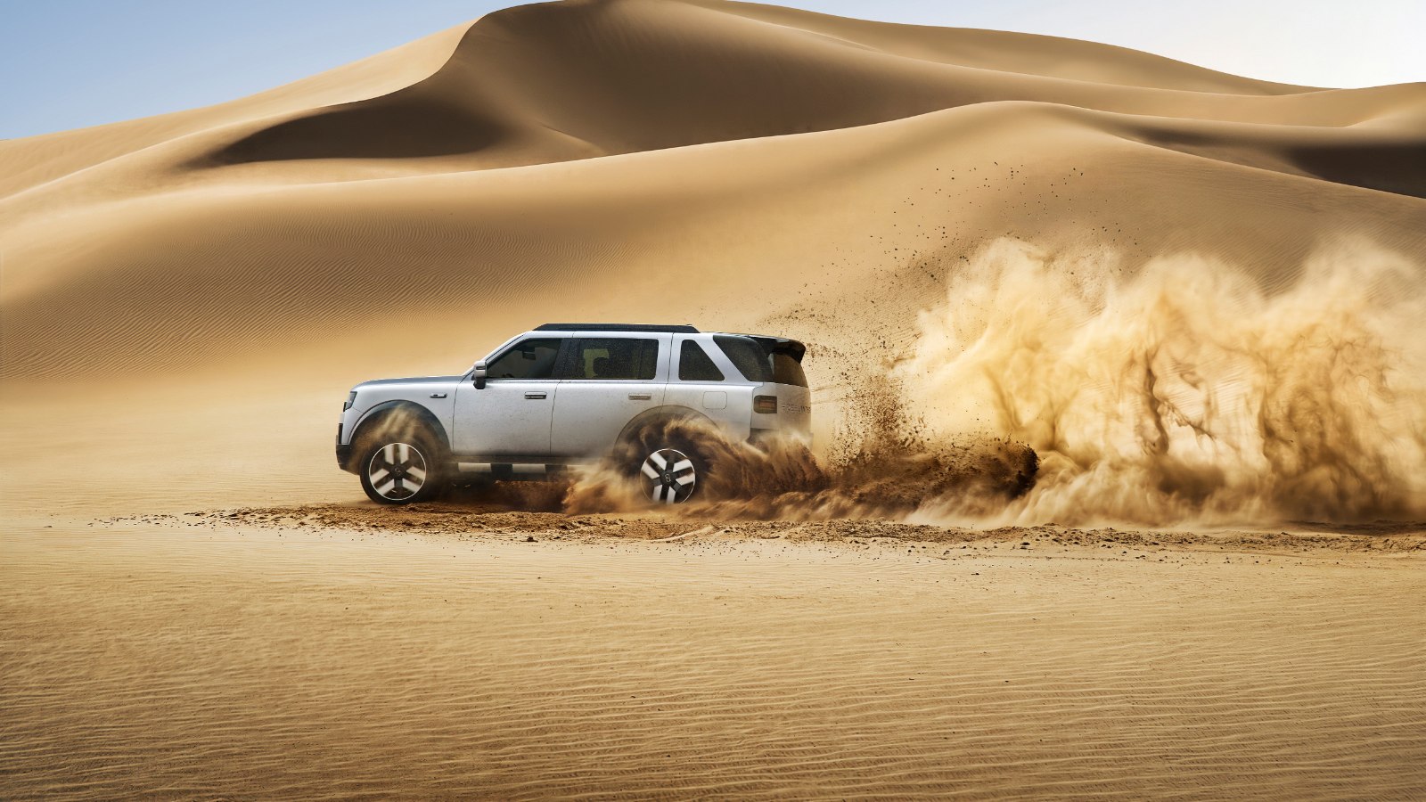 A FREELANDER 8 kicks up sand during desert testing ahead of its UAE launch