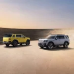 FREELANDER 8 SUVs in yellow and silver on the launch stage backdrop ahead of the brand's Abu Dhabi debut