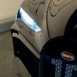 black and silver car with black and blue round cover