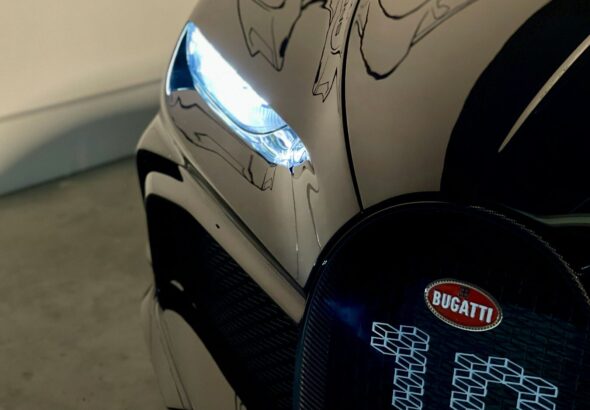 black and silver car with black and blue round cover