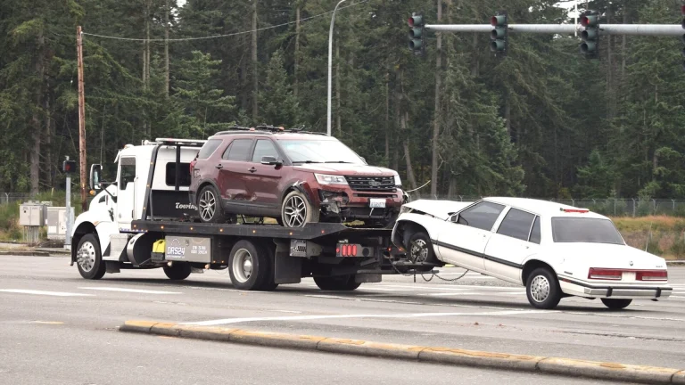A tow truck towing a car on the road