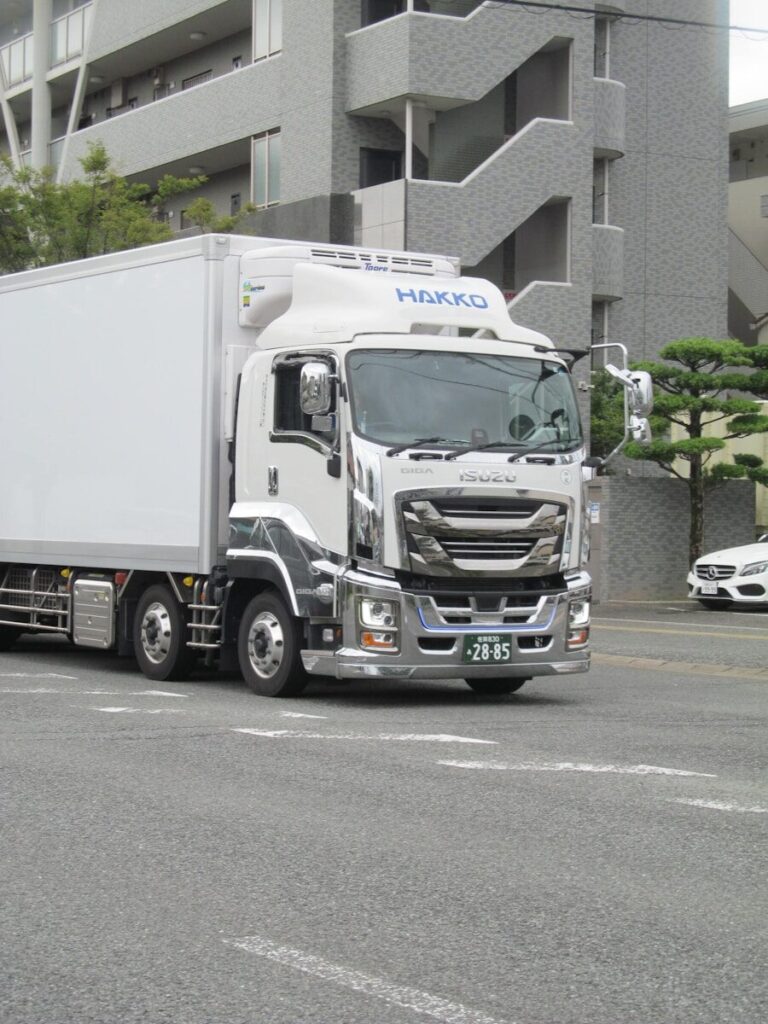White delivery truck with chrome accents on road