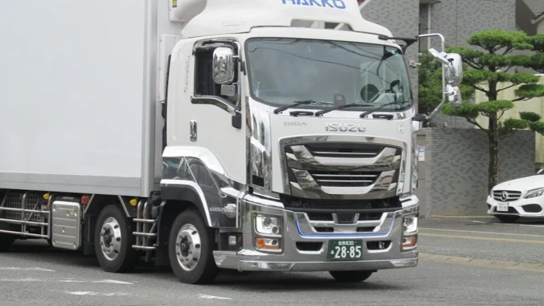 White delivery truck with chrome accents on road