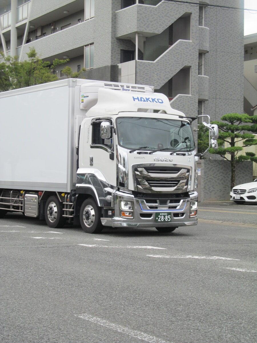 White delivery truck with chrome accents on road