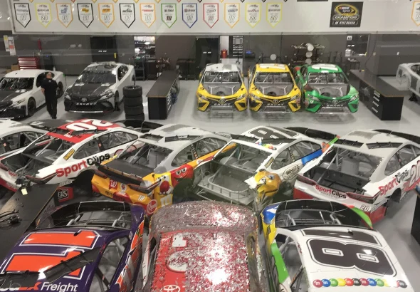 Rows of Joe Gibbs Racing Cup Series cars on the team's shop floor in Huntersville, North Carolina