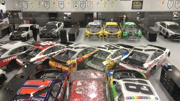 Rows of Joe Gibbs Racing Cup Series cars on the team's shop floor in Huntersville, North Carolina