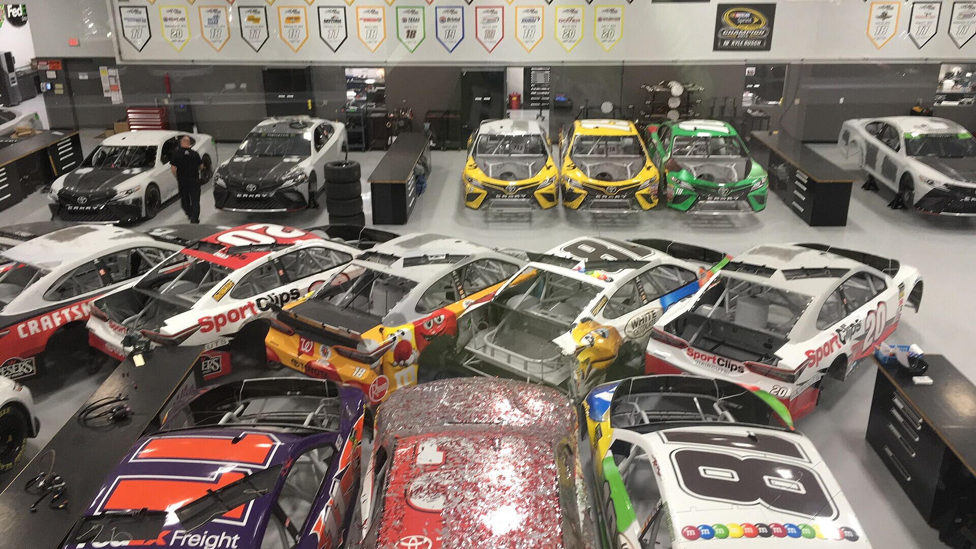Rows of Joe Gibbs Racing Cup Series cars on the team's shop floor in Huntersville, North Carolina