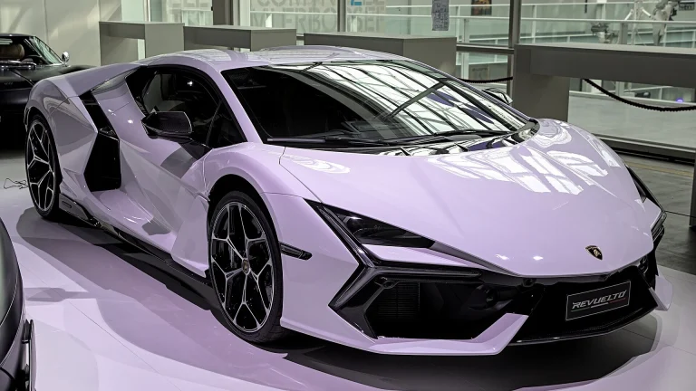 A stock Lamborghini Revuelto in pale lilac paint shown from the front three-quarter angle