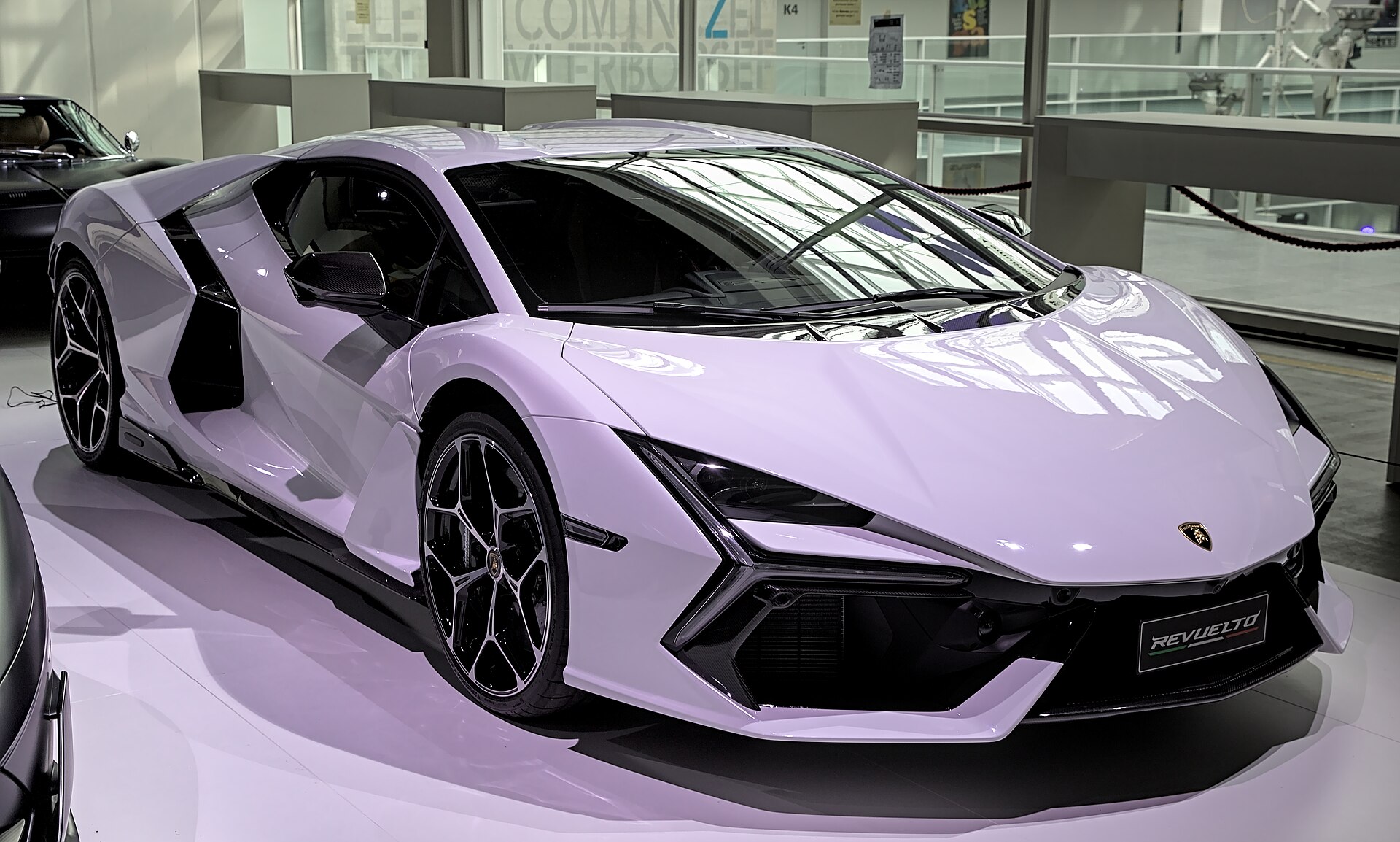 A stock Lamborghini Revuelto in pale lilac paint shown from the front three-quarter angle