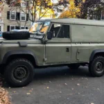 Classic Land Rover Defender 110 hardtop parked on a US city street