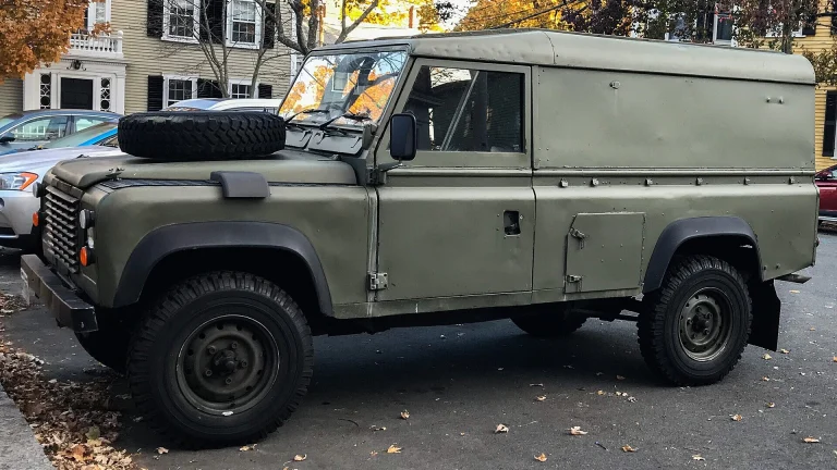 Classic Land Rover Defender 110 hardtop parked on a US city street