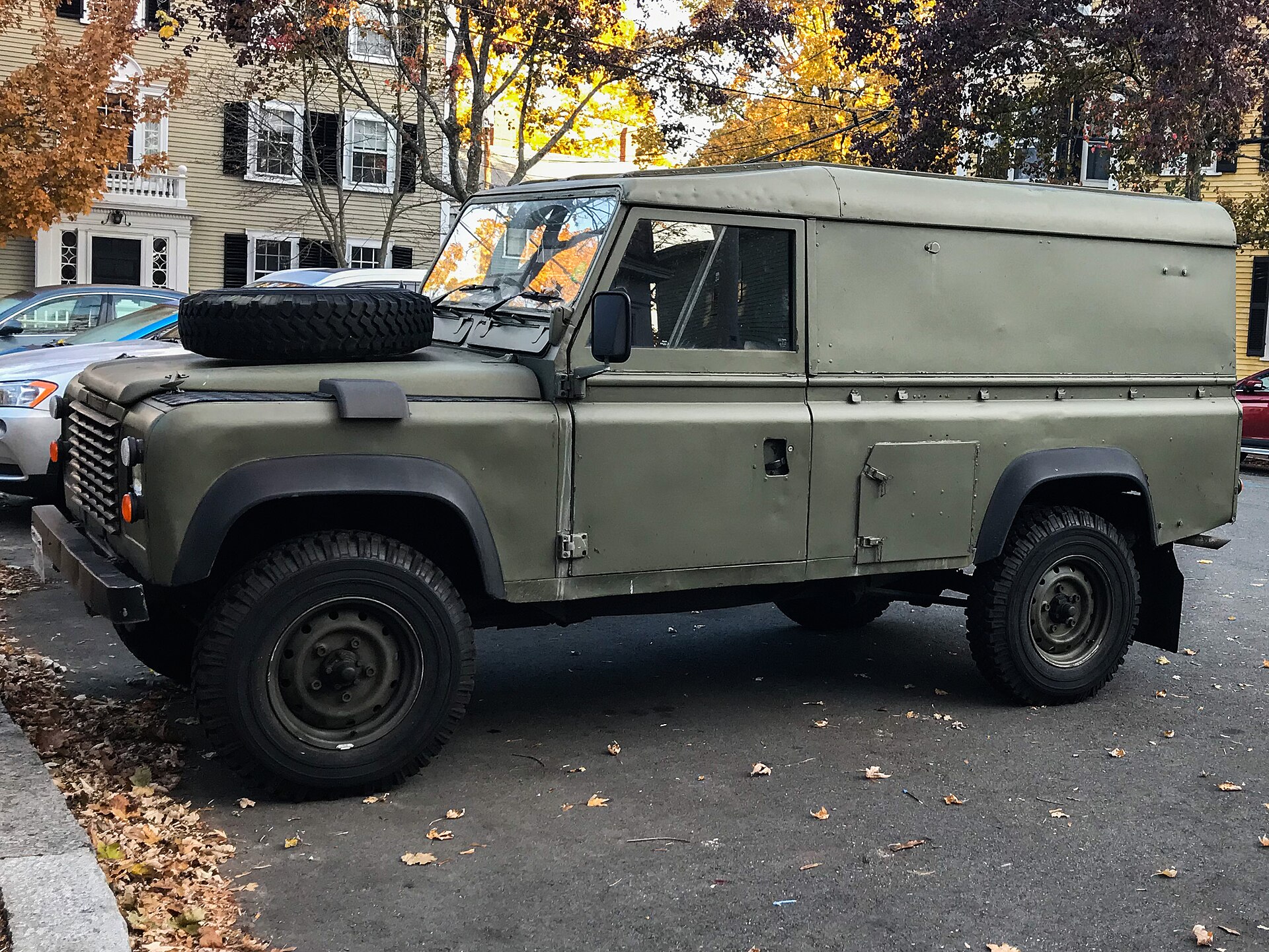 Classic Land Rover Defender 110 hardtop parked on a US city street