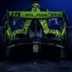 LN4 Fusion race car in the team's dark navy and neon green livery, rear three-quarter studio shot