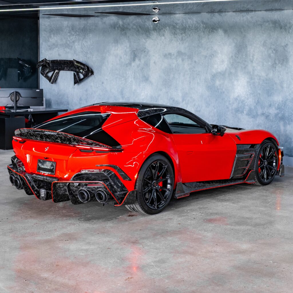 Rear three-quarter view of Mansory Ferrari 12Cilindri showing carbon ducktail spoiler, diffuser and quad exhaust tips