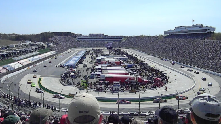Cars racing at Martinsville Speedway with the grandstands full