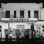 Black and white archival photo of the McLaren's sign above Bruce McLaren's parents' service station in Remuera, Auckland, the inspiration for McLaren's new wordmark