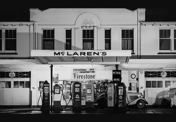 Black and white archival photo of the McLaren's sign above Bruce McLaren's parents' service station in Remuera, Auckland, the inspiration for McLaren's new wordmark