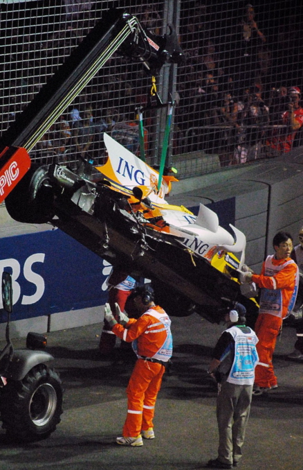 Marshals recover Nelson Piquet Jr.’s crashed Renault at the 2008 Singapore Grand Prix