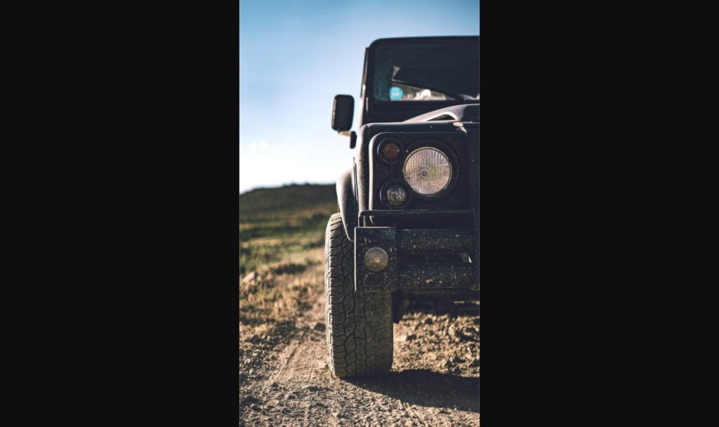 Close-up of a rugged 4x4's front end and off-road tire, illustrating the beadlock wheel and tire setup style of the Trail-Ready concept
