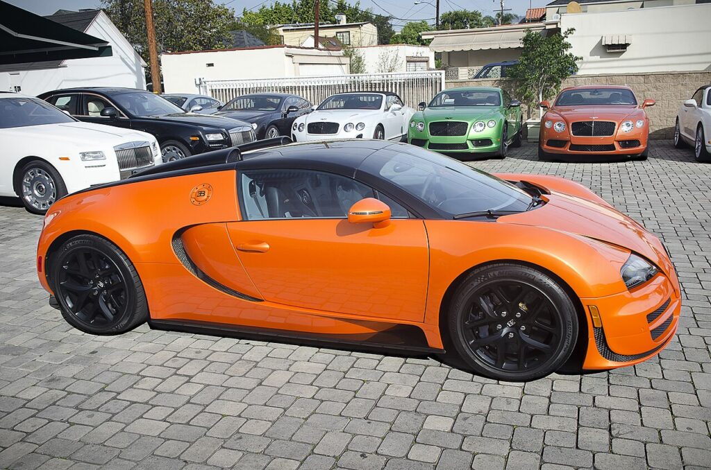 Orange Bugatti Veyron Grand Sport Vitesse roadster parked on a paver lot