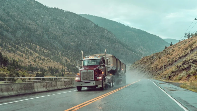 red and white truck on road during daytime
