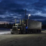 Peterbilt big rig parked in the dark before sunrise