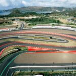 An aerial view of a race track with cars on it