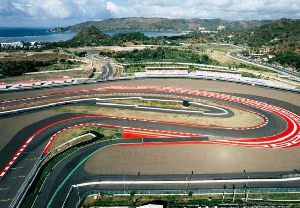 An aerial view of a race track with cars on it