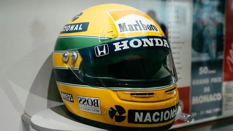 A yellow racing helmet with honda and marlboro logos
