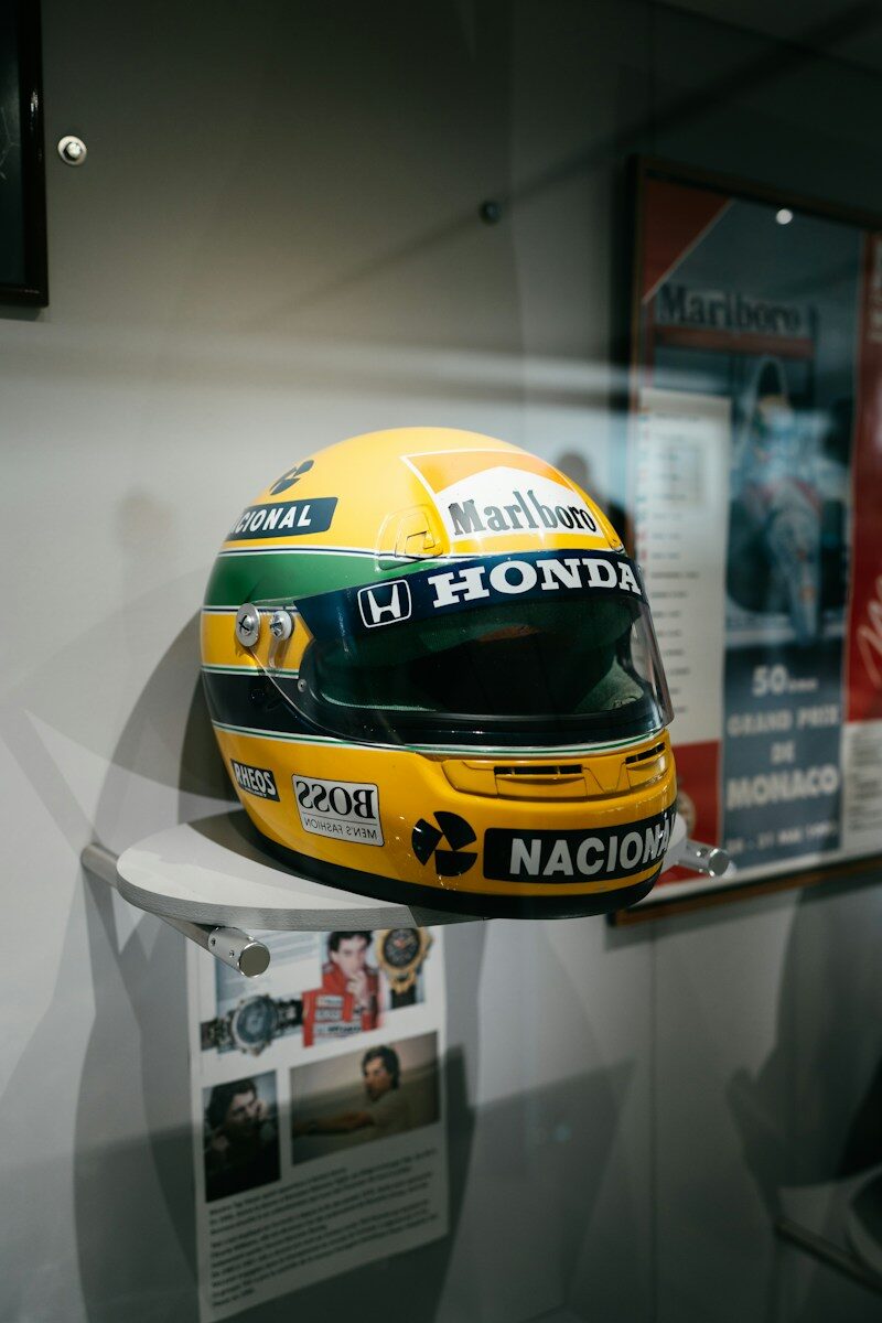 A yellow racing helmet with honda and marlboro logos