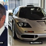 Rowan Atkinson next to a silver McLaren F1