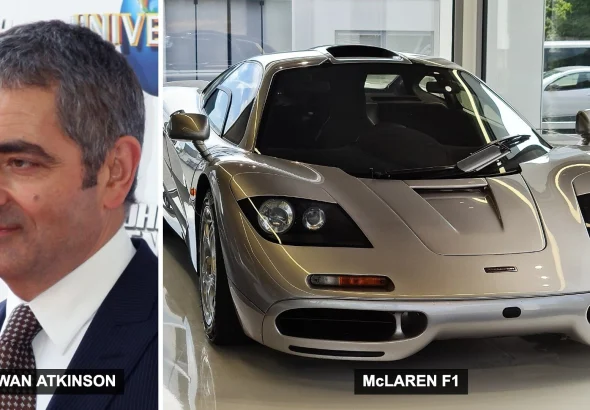 Rowan Atkinson next to a silver McLaren F1