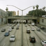 Traffic backed up on a Los Angeles freeway under a hazy, smog-filled sky