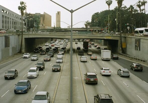 Traffic backed up on a Los Angeles freeway under a hazy, smog-filled sky