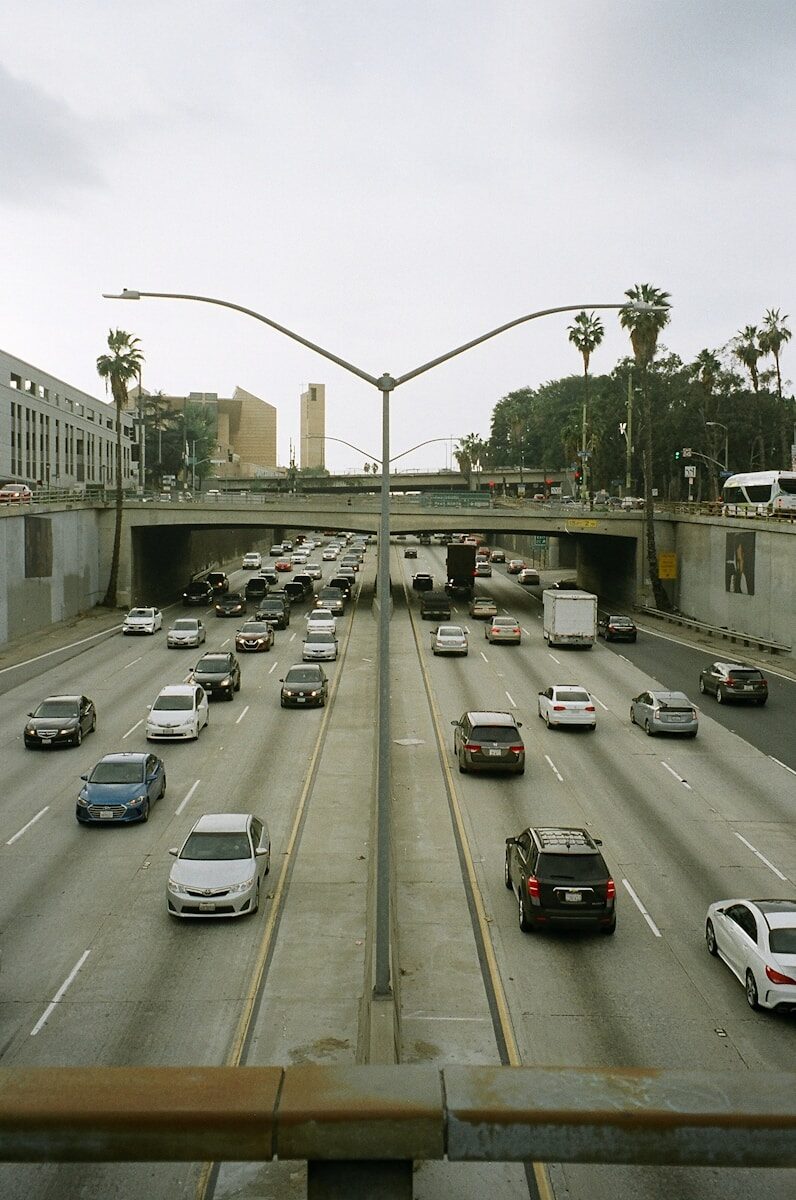 Traffic backed up on a Los Angeles freeway under a hazy, smog-filled sky