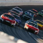 Race cars speeding around a track during a race