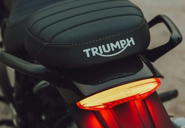 Black motorcycle seat with triumph logo and brake light