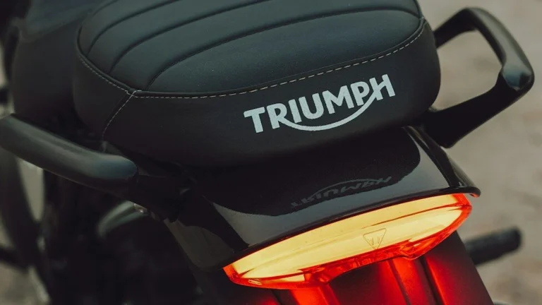 Black motorcycle seat with triumph logo and brake light
