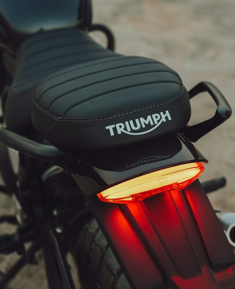 Black motorcycle seat with triumph logo and brake light